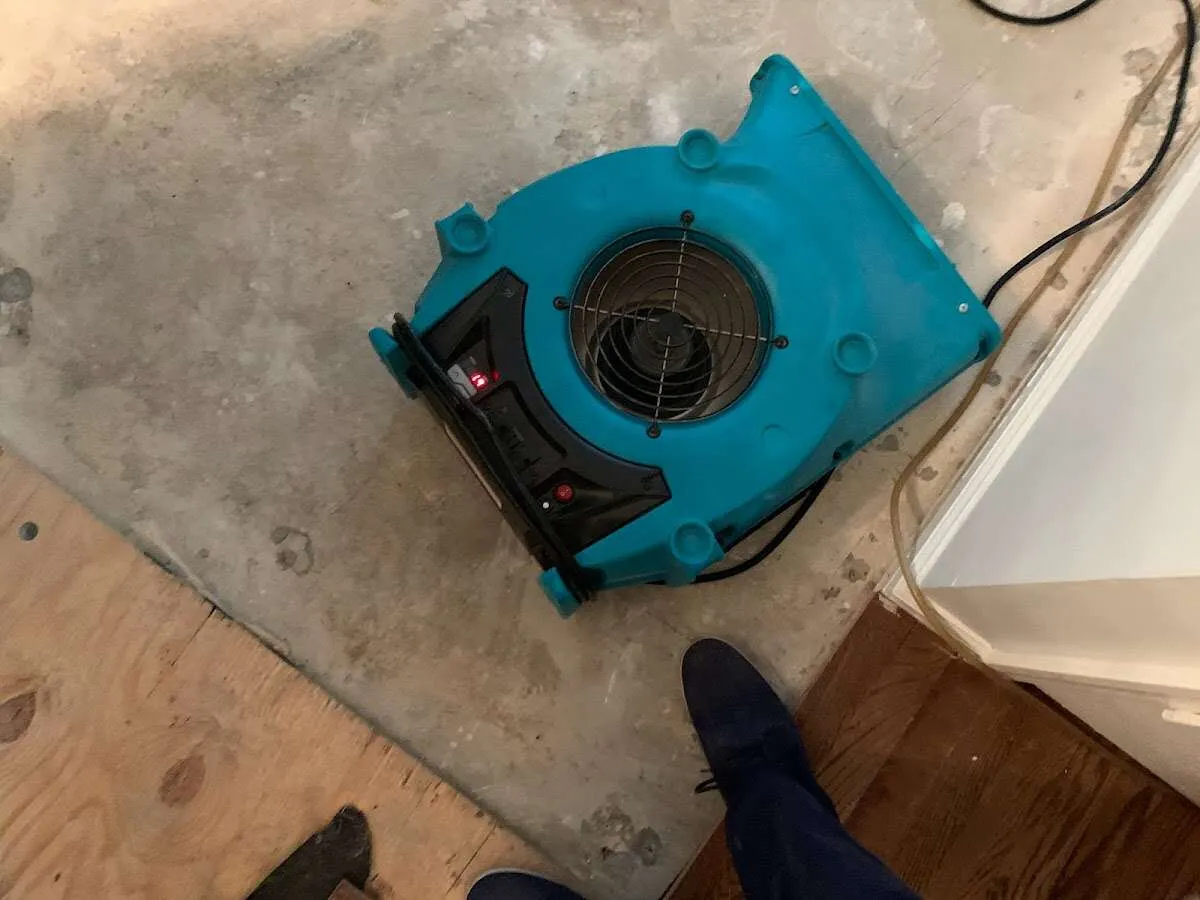 Air mover drying subfloor during Commercial Water Damage Restoration in East Palo Alto